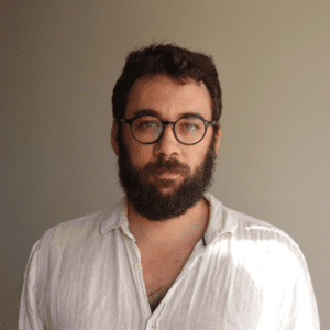 A photo of a man in a white shirt