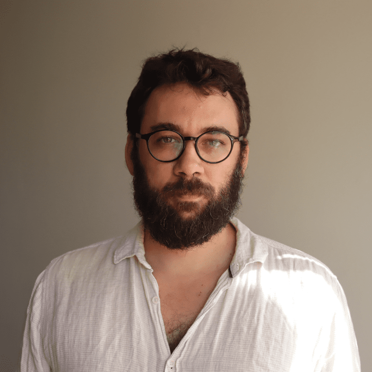 A photo of a man in a white shirt